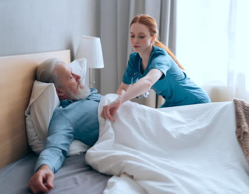 Night carer helping with medication and repositioning support